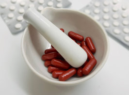 red pills inside a mortal and a pestle