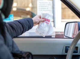 Man picking up a prescription at the pharmacy drive-up window safely and conveniently