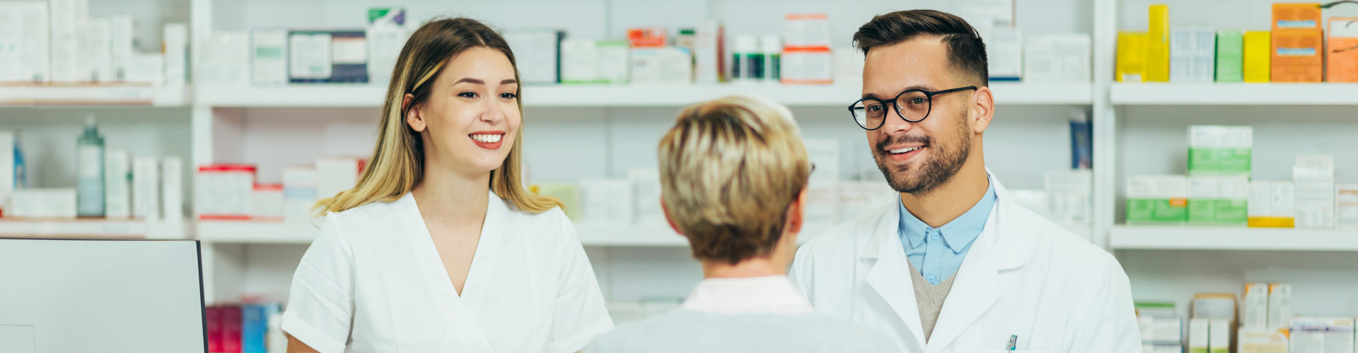 two pharmacists smiling at the customer