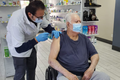 medical worker immunizing mature patient against virus