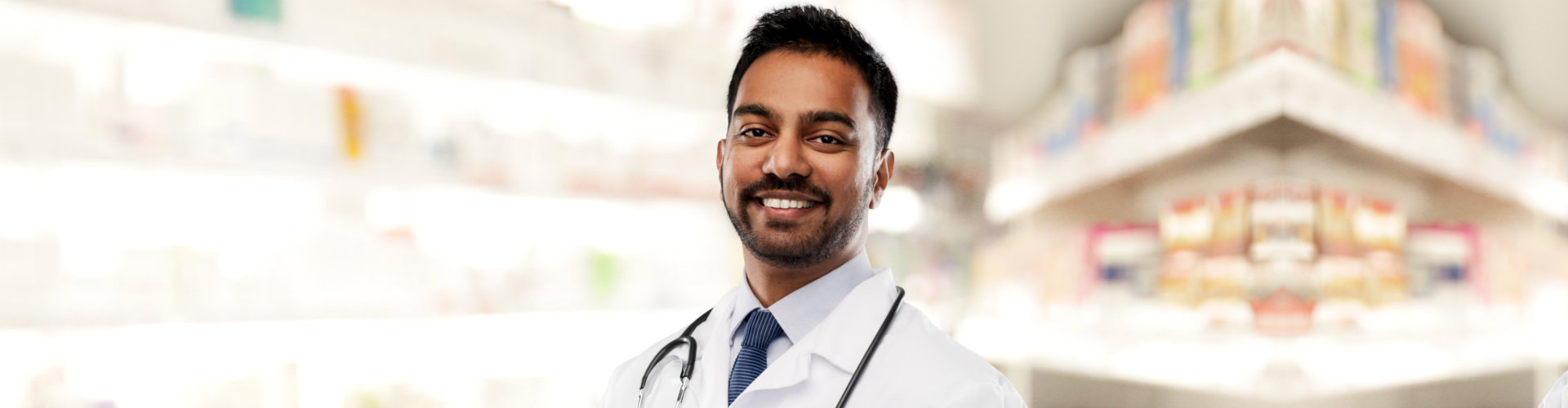 a male pharmacist smiling