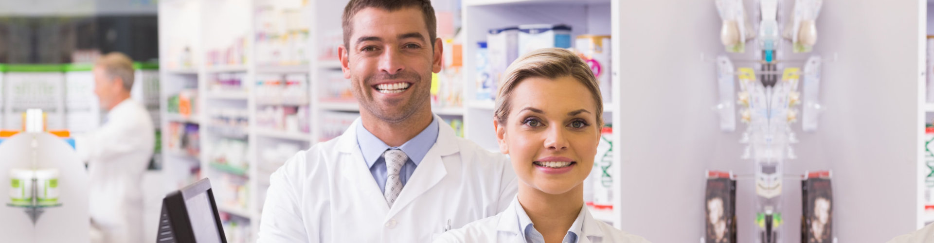 two pharmacists smiling in a pharmacy